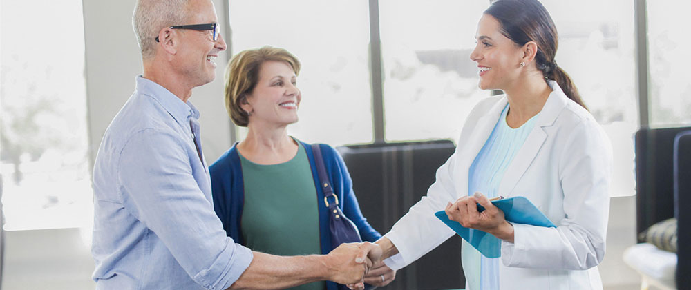 Couple in Clinic Shaking Hands with Professional
